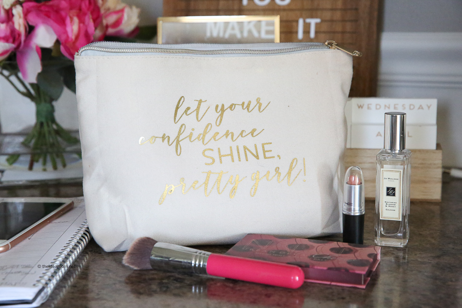 Cricut makeup pouch made with lipstick, makeup brush, and perfume